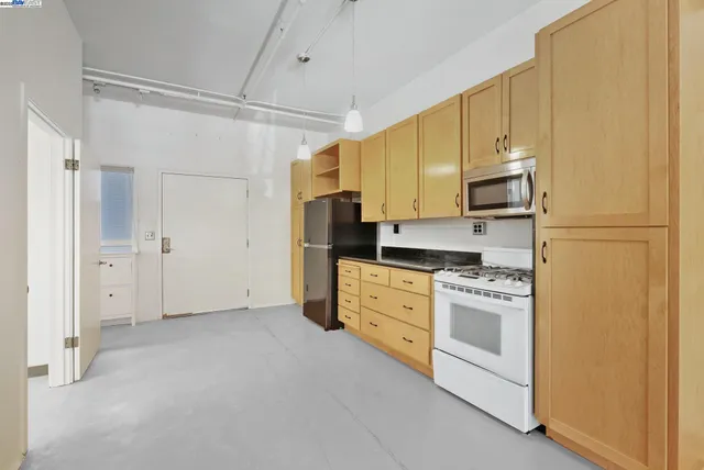 a kitchen with stainless steel appliances a refrigerator sink and stove