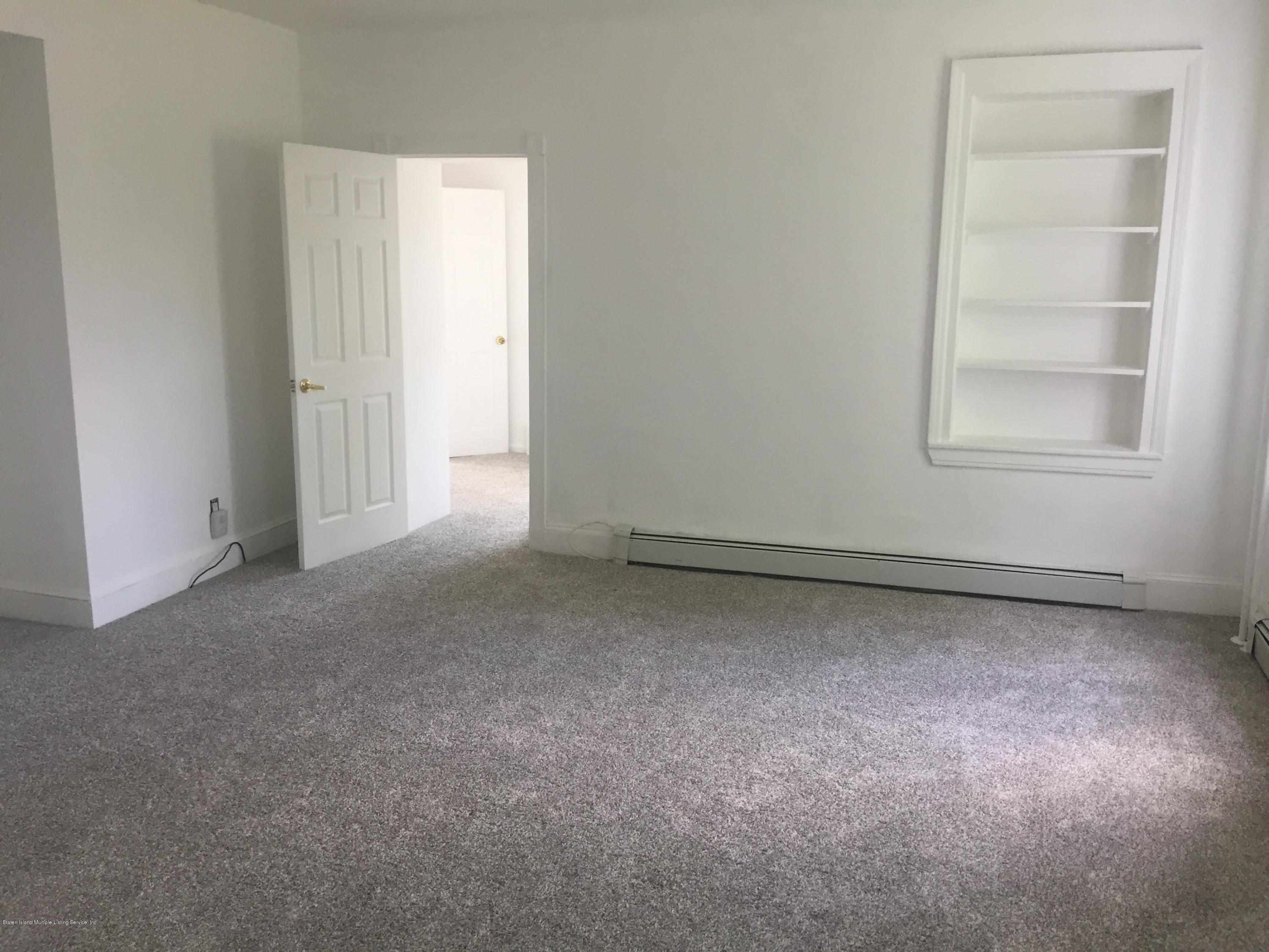 2703 Amboy Road Staten Island, NY 10306 - Photo 5 of 8 an empty room with windows and closet