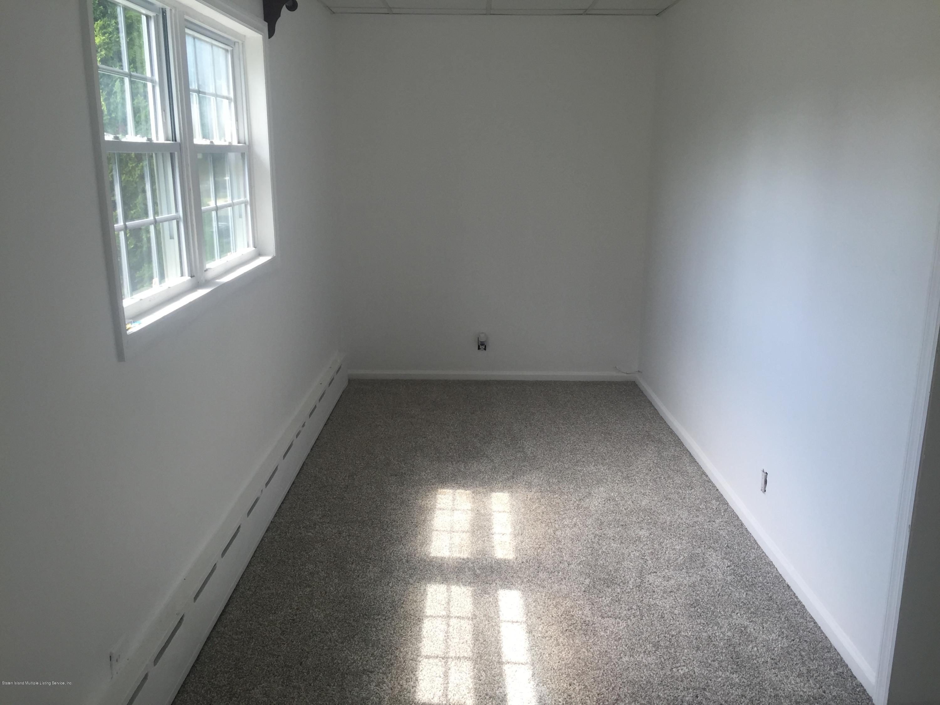 2703 Amboy Road Staten Island, NY 10306 - Photo 6 of 8 an empty room with windows