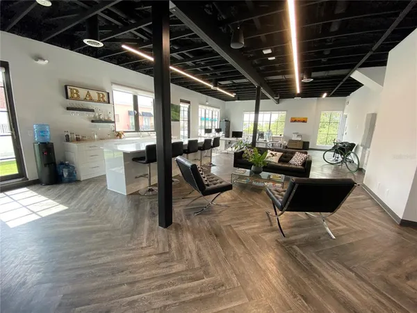 a living room with furniture or couch and a dining table with wooden floor