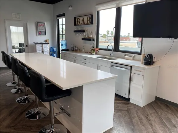 a large kitchen with a table chairs and a sink