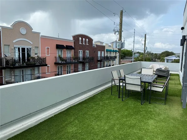 a view of a porch with chairs and backyard
