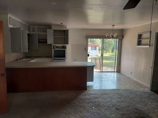 a view of kitchen with kitchen island stainless steel appliances a sink stove and refrigerator