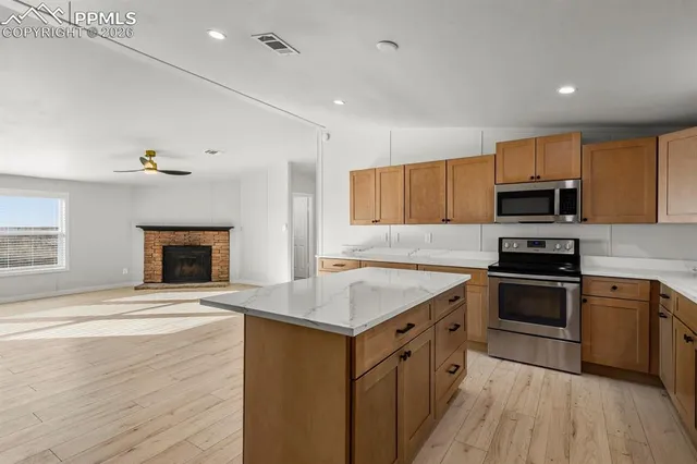 a kitchen with a sink stove and microwave