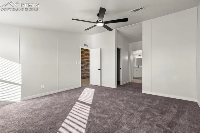 a view of a livingroom with a ceiling fan and window