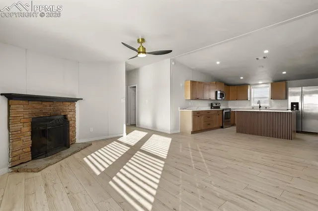 a view of a kitchen with a sink and a fireplace