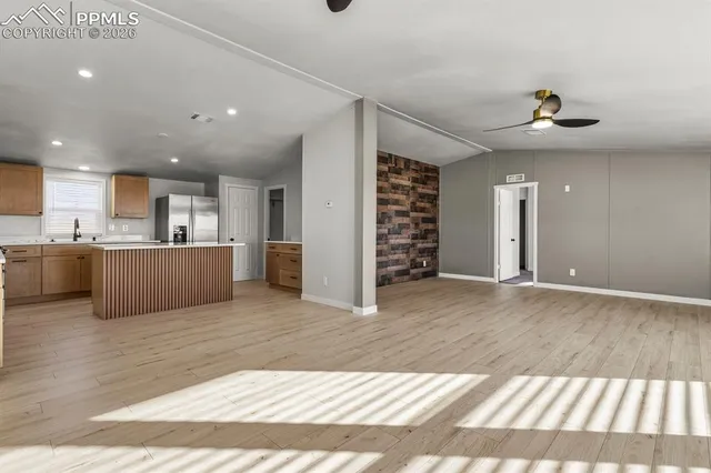 a view of a kitchen with a sink and a kitchen view
