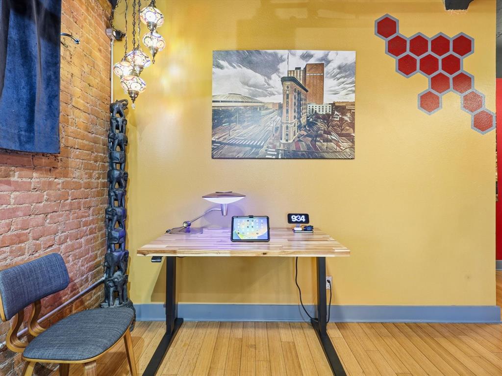 910 Houston Street, Unit 305 Fort Worth, TX 76102 - Photo 11 of 22 a view of a workspace with furniture and wooden floor