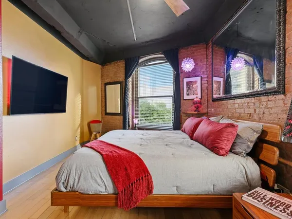 a bedroom with a bed and a flat screen tv