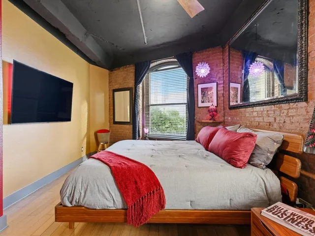 a bedroom with a bed and a flat screen tv