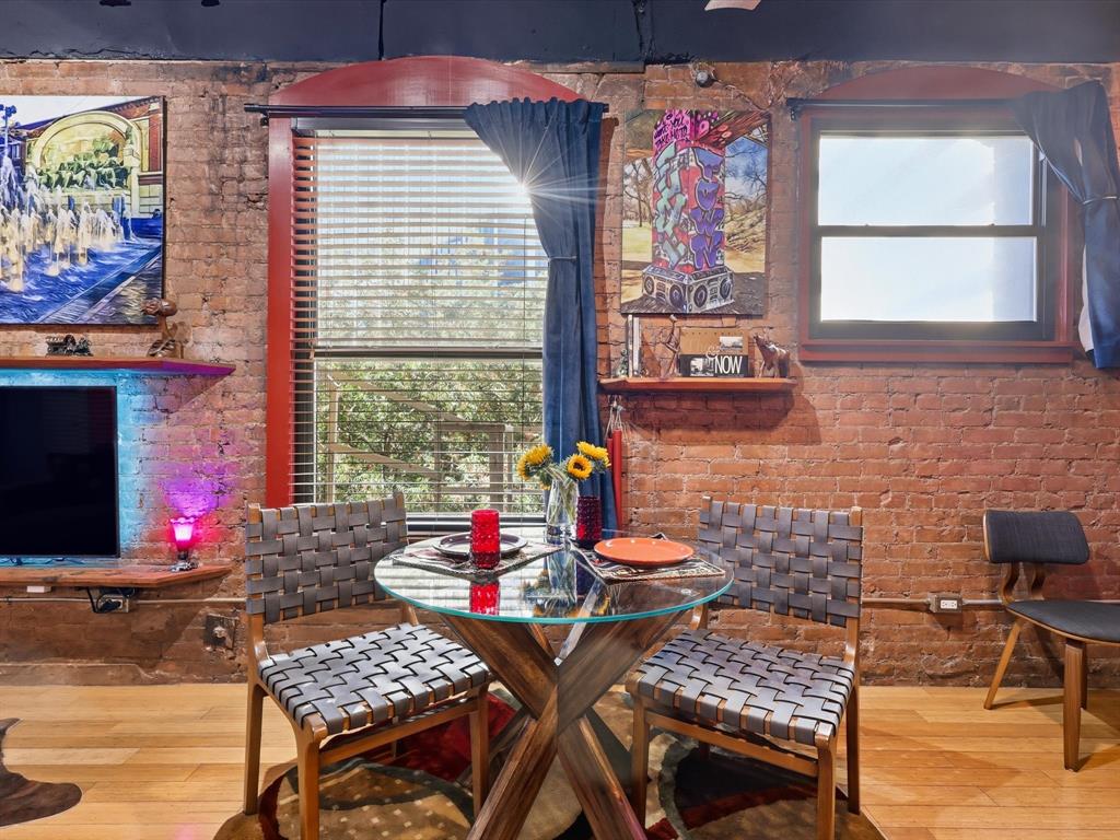 910 Houston Street, Unit 305 Fort Worth, TX 76102 - Photo 9 of 22 a dining area with furniture and window