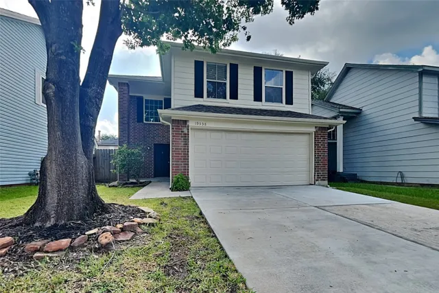 a front view of a house with swimming pool and porch
