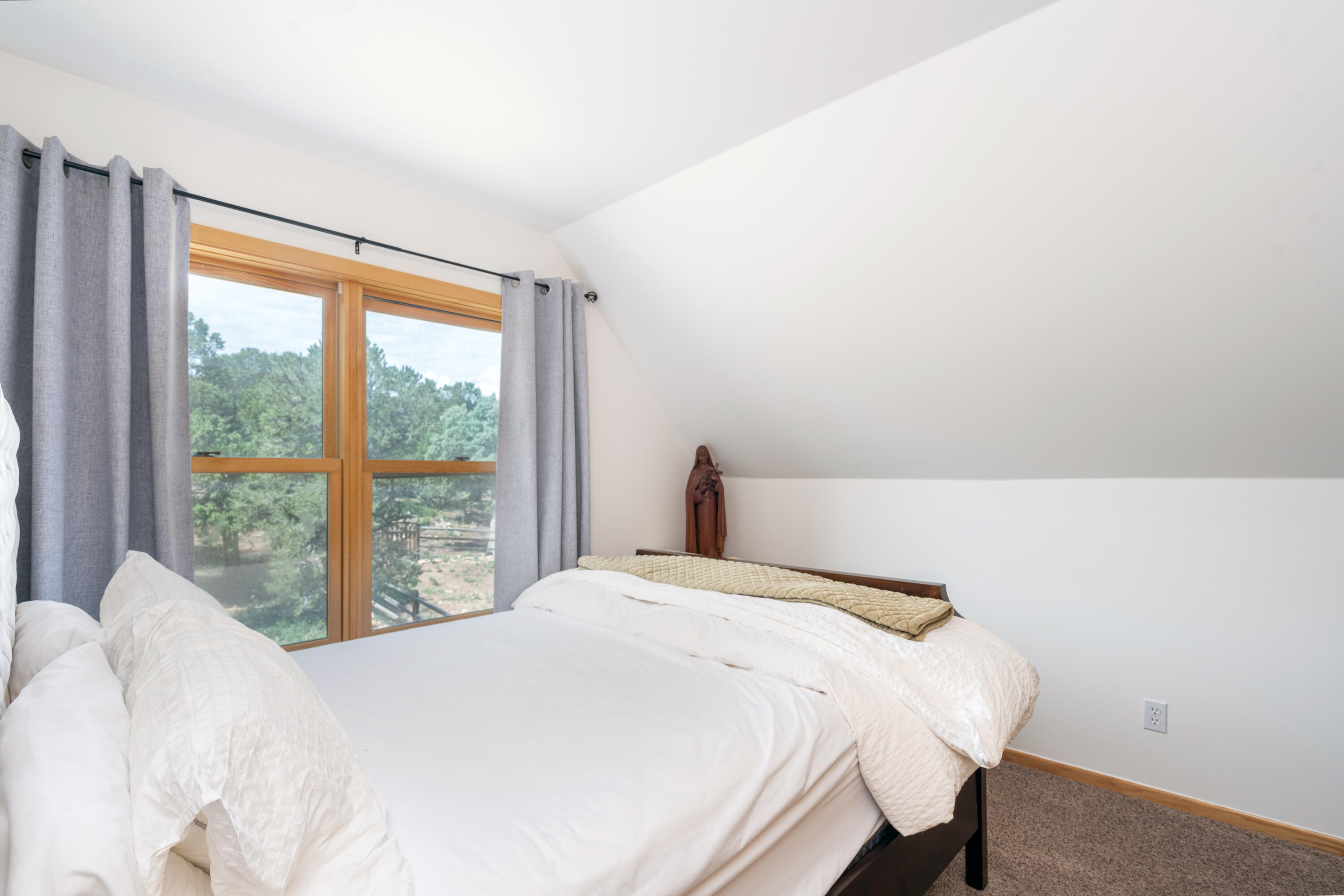 787 Pine Drive Ridgway, CO 81432 - Photo 17 of 42 a bedroom with a bed and a large window