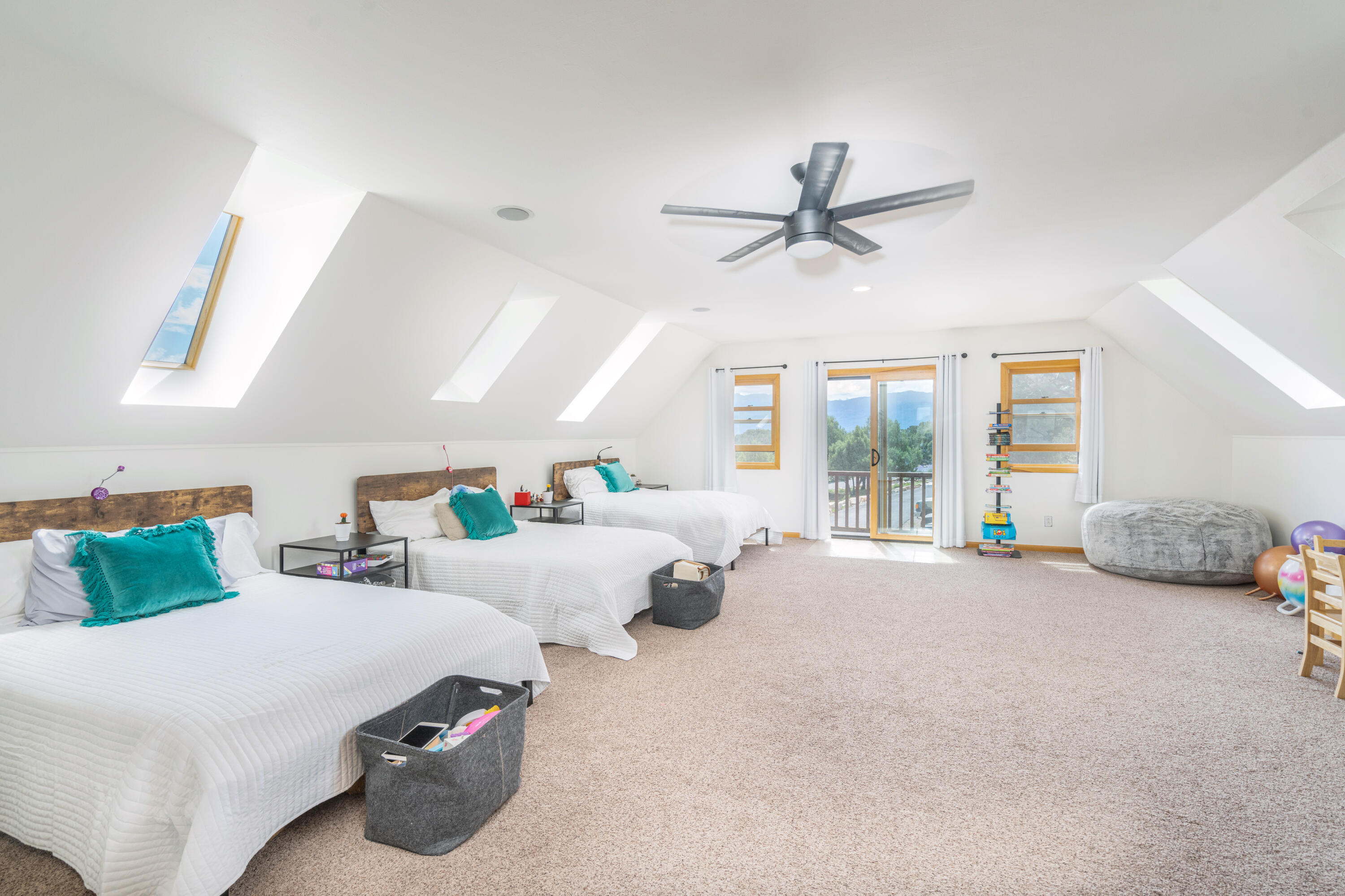 787 Pine Drive Ridgway, CO 81432 - Photo 21 of 42 a living room with furniture ceiling fan and a large window