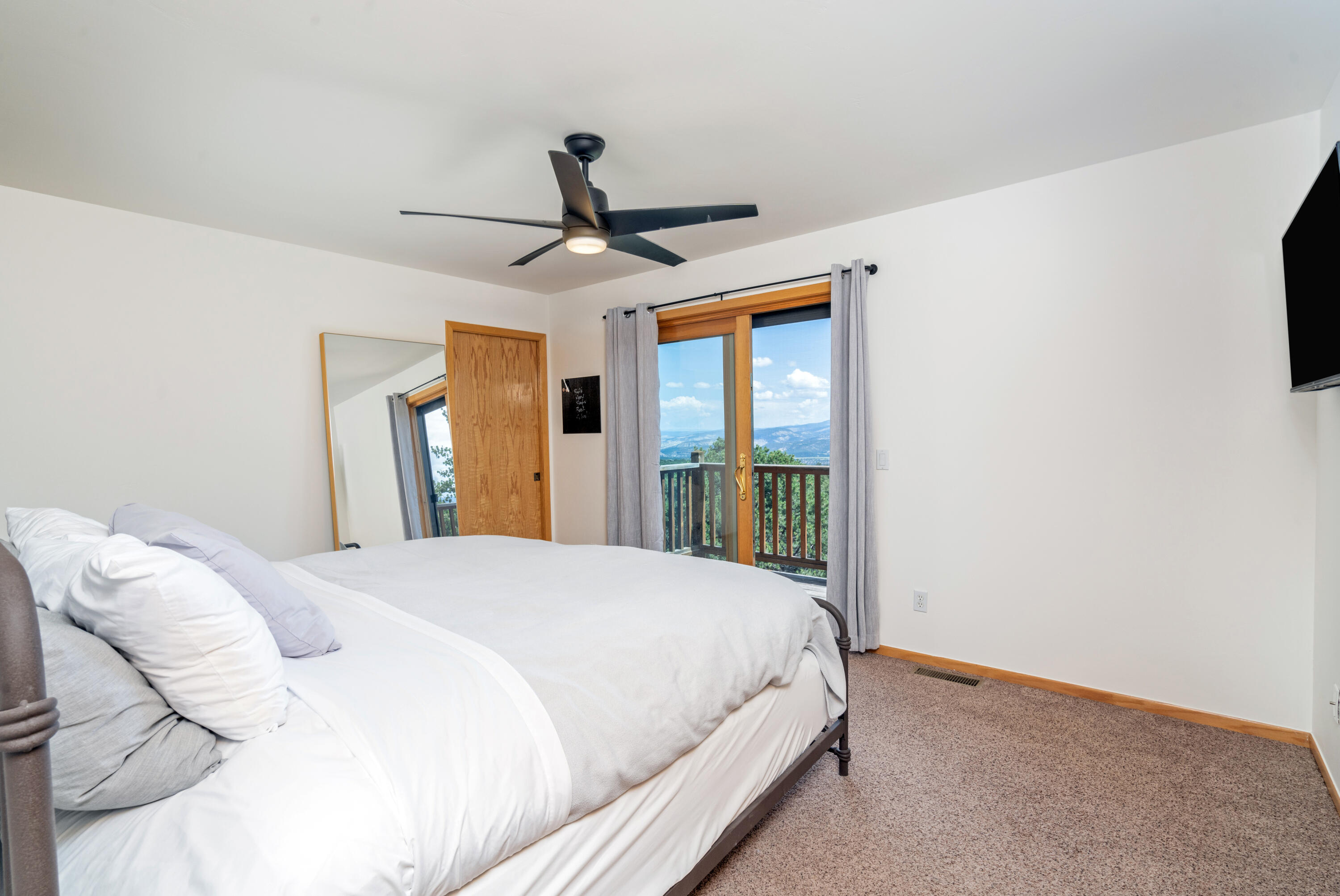 787 Pine Drive Ridgway, CO 81432 - Photo 25 of 42 a bedroom with a bed and a large window