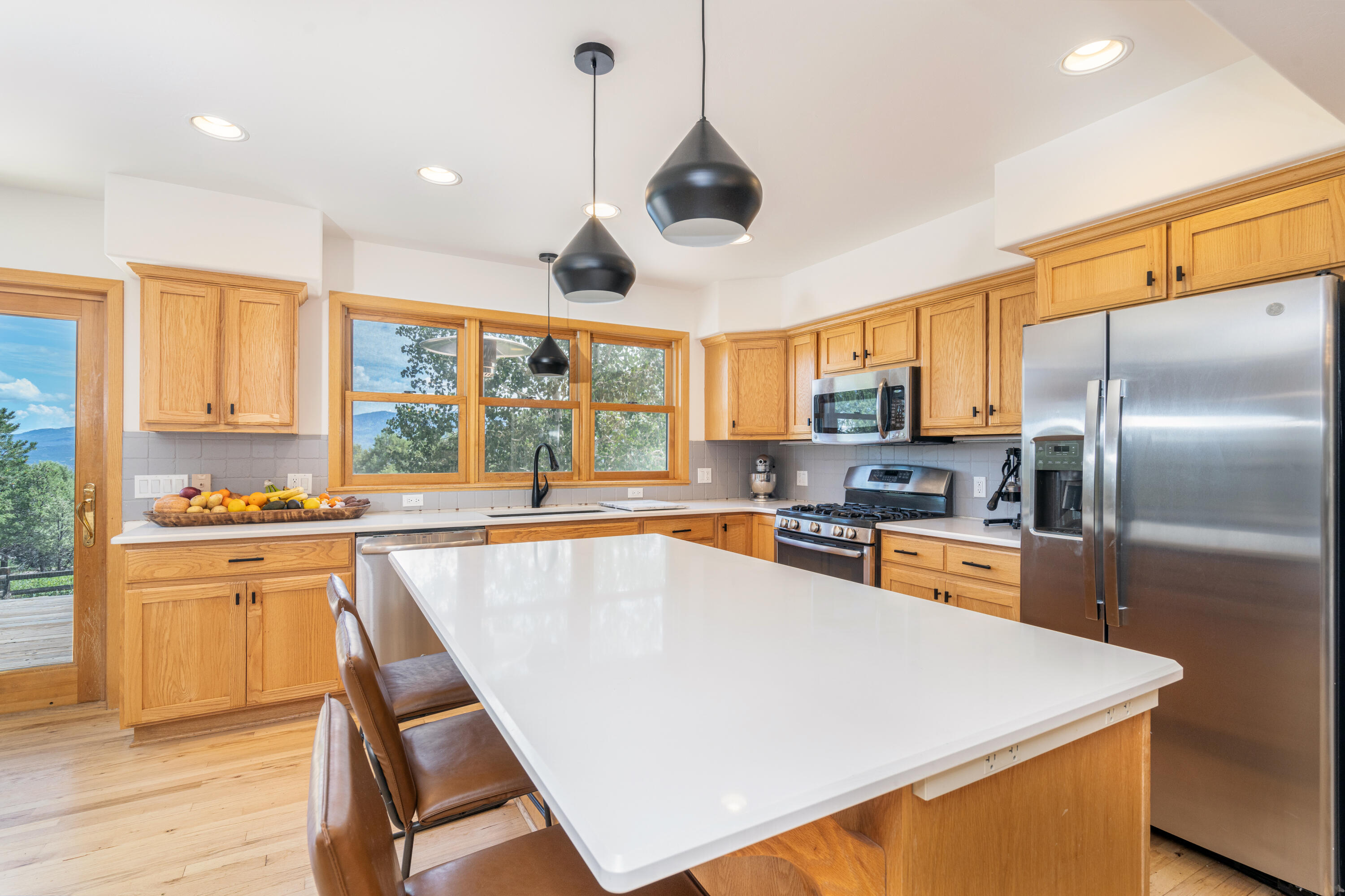787 Pine Drive Ridgway, CO 81432 - Photo 3 of 42 a large kitchen with stainless steel appliances granite countertop a sink a stove and a refrigerator