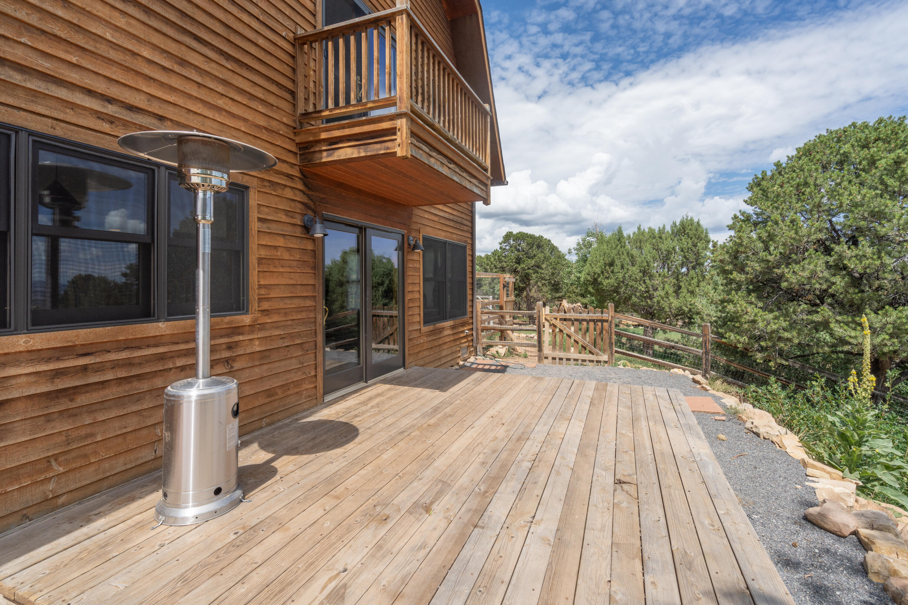 787 Pine Drive Ridgway, CO 81432 - Photo 37 of 42 a view of a patio with table and chairs with wooden floor and fence
