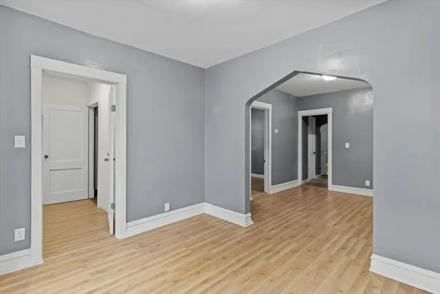 a view of a livingroom with wooden floor and closet area