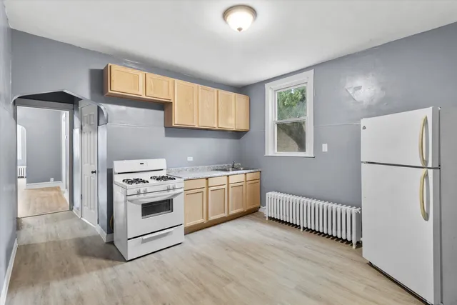 a kitchen with a stove a refrigerator and a sink
