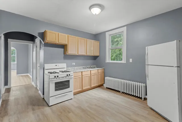 a kitchen with a stove a refrigerator and a sink