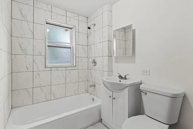 a bathroom with a sink mirror toilet and bathtub