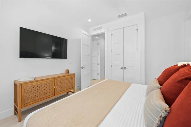 a bedroom with a bed and a dresser