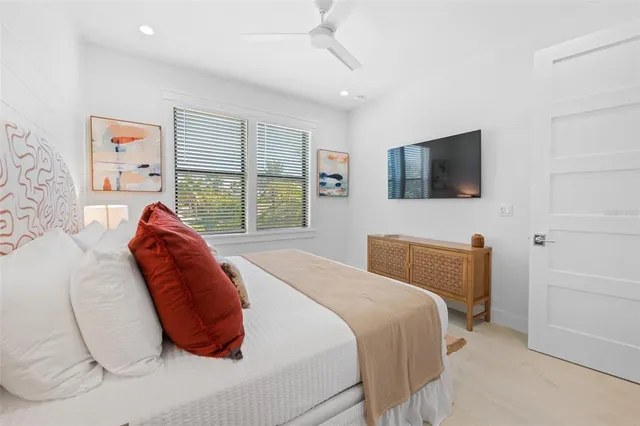a bedroom with a bed and a painting on the wall
