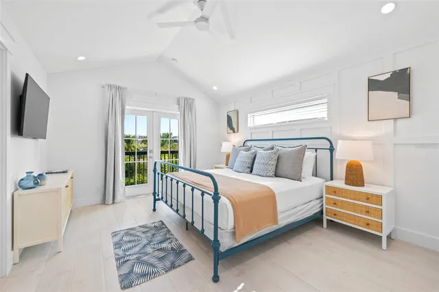 a view of road with card parked on side and retail shops