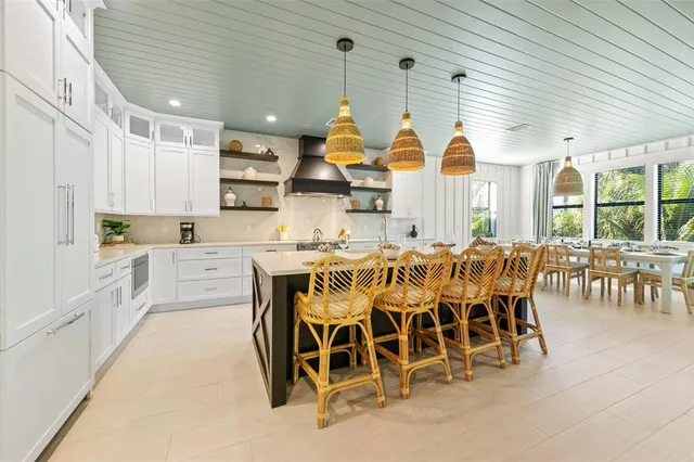 a kitchen with stainless steel appliances kitchen island granite countertop a sink and cabinets