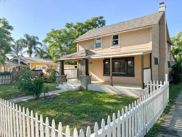 a front view of house with yard and green space