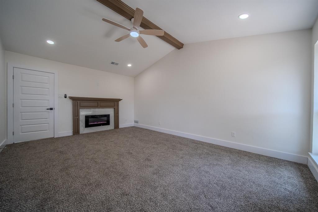 142 Ridgegate Drive Garland, TX 75040 - Photo 19 of 26 Carpeted room featuring a vaulted ceiling with a wood-finish beam and ceiling fan