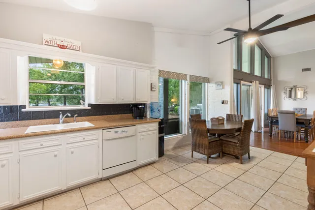 a large white kitchen with cabinets