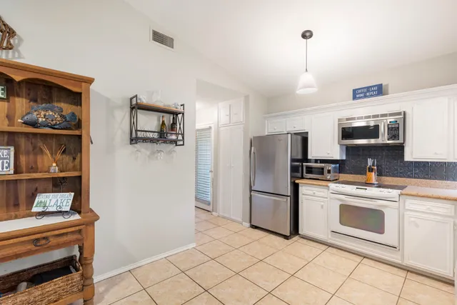 a kitchen with granite countertop cabinets and steel stainless steel appliances