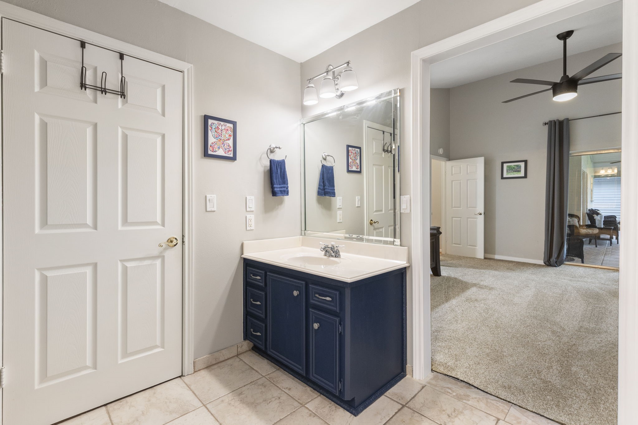245 Lakeland Road Huntsville, TX 77320 - Photo 24 of 49 a bathroom with a sink vanity and a mirror