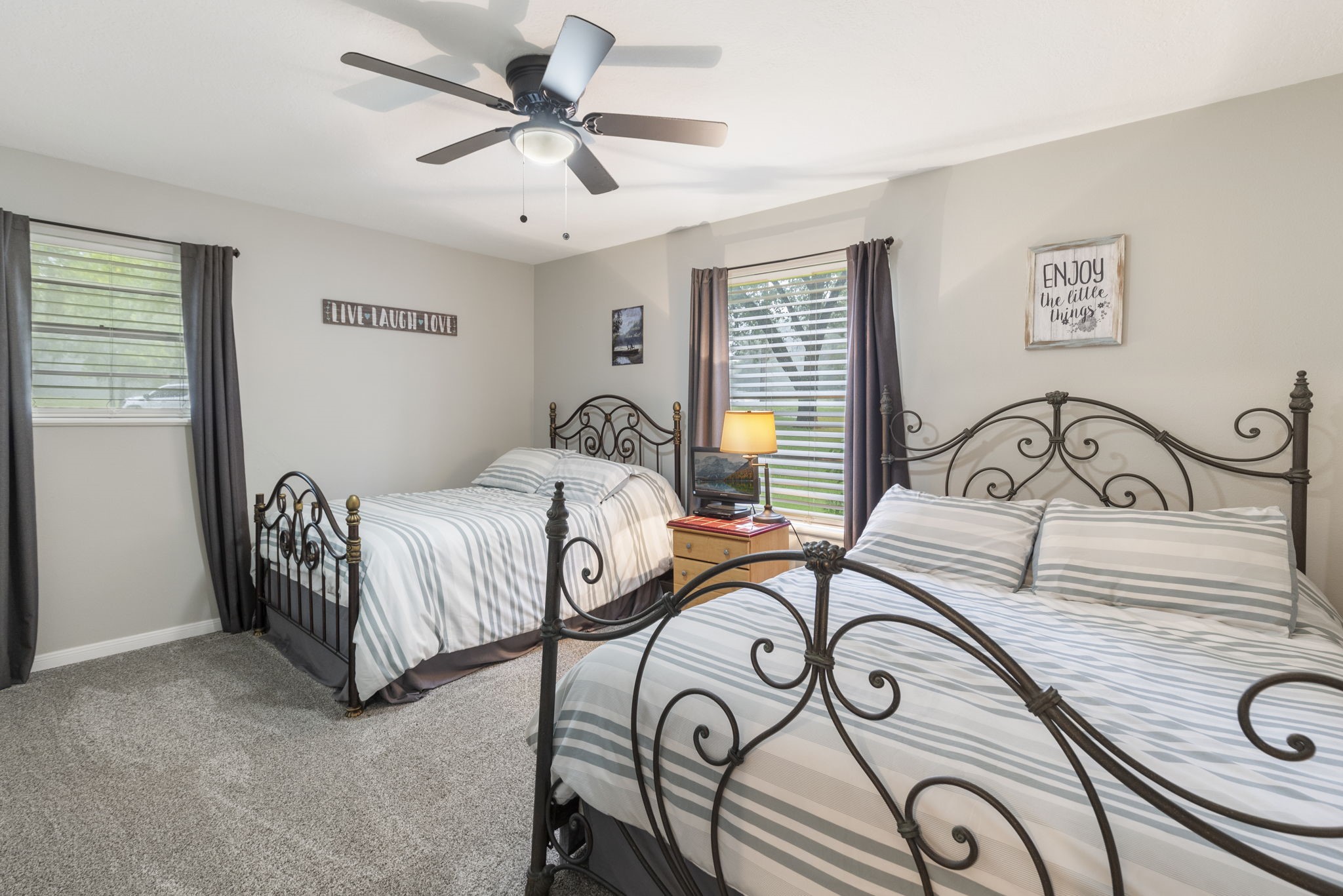 245 Lakeland Road Huntsville, TX 77320 - Photo 27 of 49 a bedroom with a bed a chandelier and a window