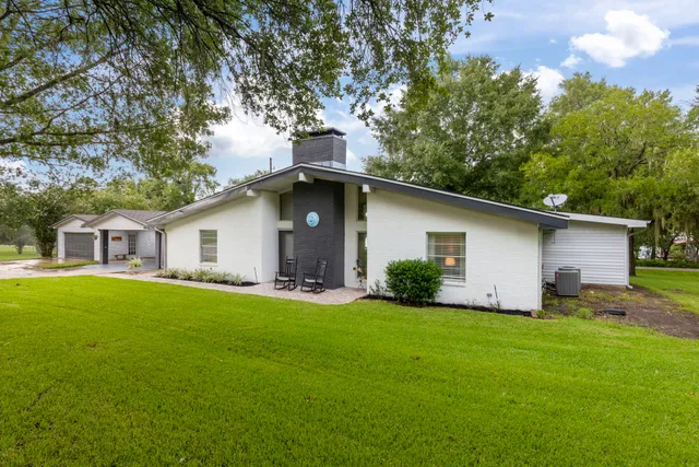 a front view of house with yard and trees