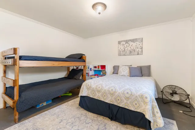 a bedroom with a bed and a dresser