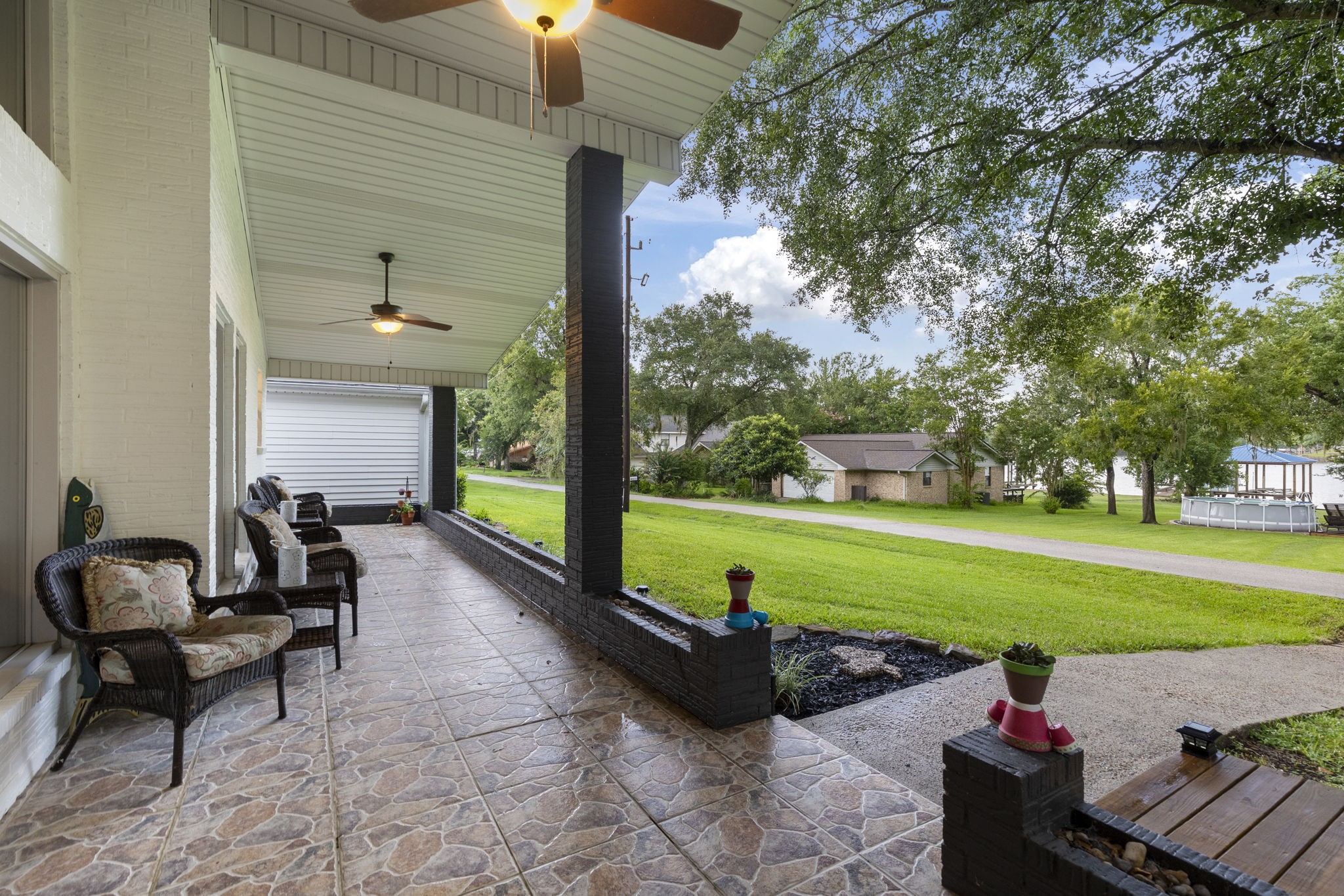 245 Lakeland Road Huntsville, TX 77320 - Photo 35 of 49 a view of a patio with couches chairs and a big yard