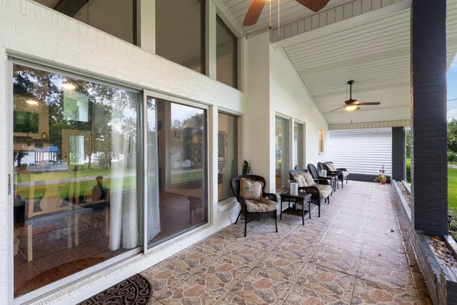a view of a porch with chairs and floor