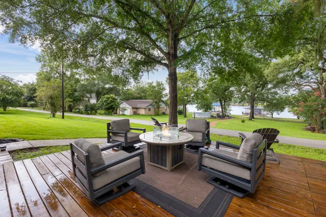 a view of a patio with couches potted plants and a big yard