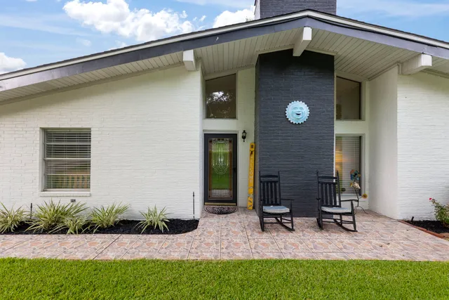 a front view of a house with garden