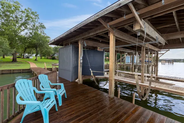 a view of a chairs and table on the wooden deck