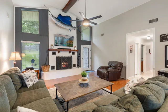 a living room with furniture a flat screen tv and a fireplace