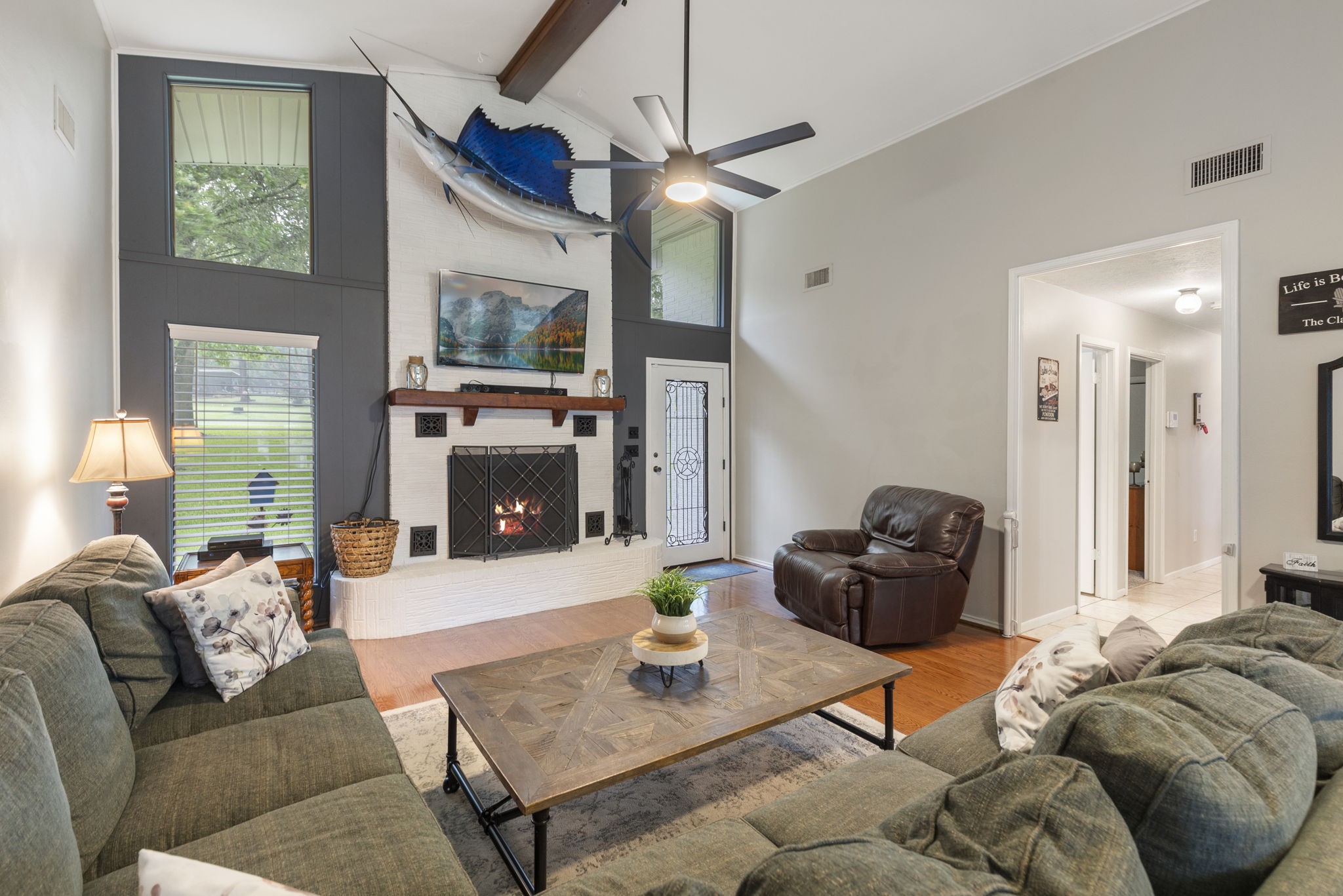 245 Lakeland Road Huntsville, TX 77320 - Photo 7 of 49 a living room with furniture a flat screen tv and a fireplace