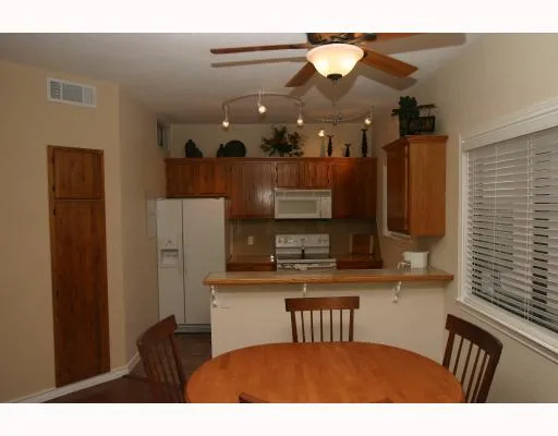 a kitchen with kitchen island a sink appliances and cabinets