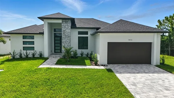 a front view of a house with a yard and garage