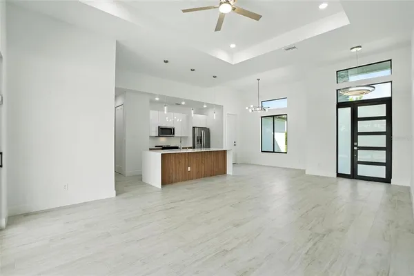 a view of a room with wooden floor and window