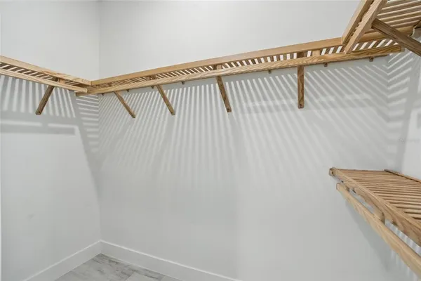 a view of an empty room and wooden floor