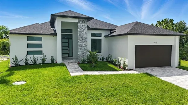 a front view of a house with a yard and garage