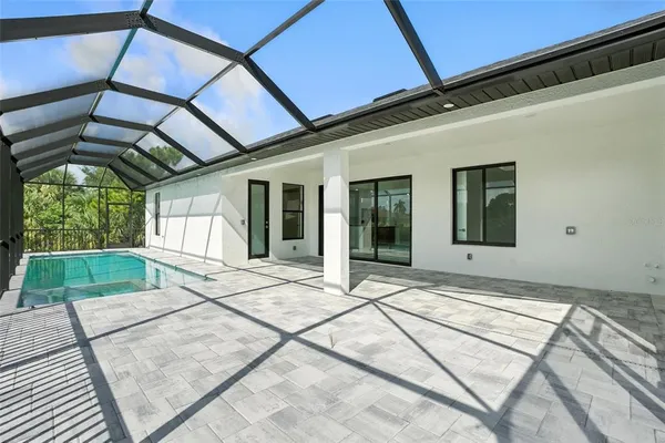 a view of a house with a yard and sitting area